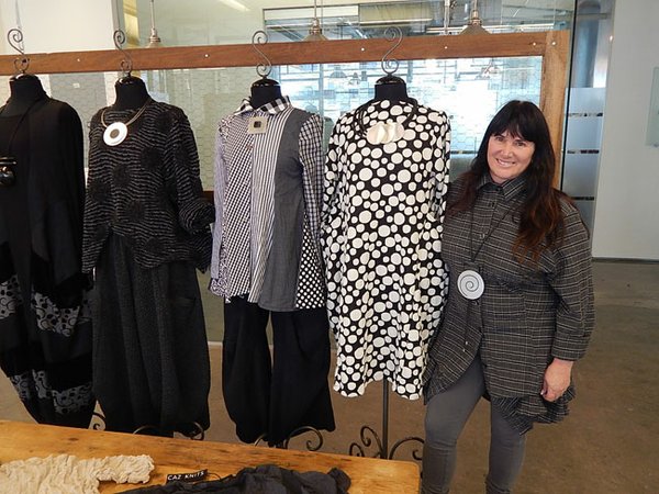 ARTSY CREATIONS: Jane Mohr stands next to her Dress to Kill styles. On the far left is a dress created by Avivit Yizhar.