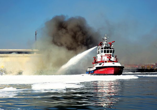 WATER POWER: A Los Angeles Fire Department boat tries to put out a fire that started Monday evening at Berth 177 at the Port of Los Angeles.