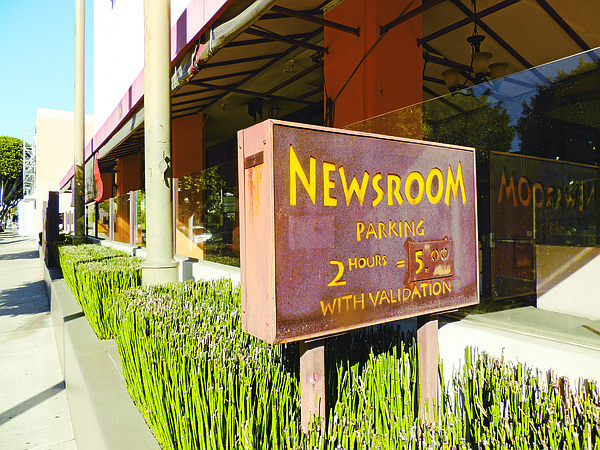 OLD SIGN: A sign for Newsroom Café, which closed on Robertson Boulevard in September. The restaurant was an anchor for the street.