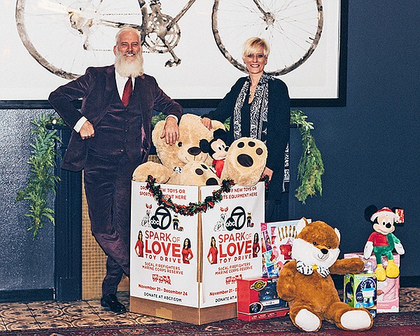 Fashion Santa and Celeste Boehm, UBM vice president of retail engagement, with toys collected for Spark of Love