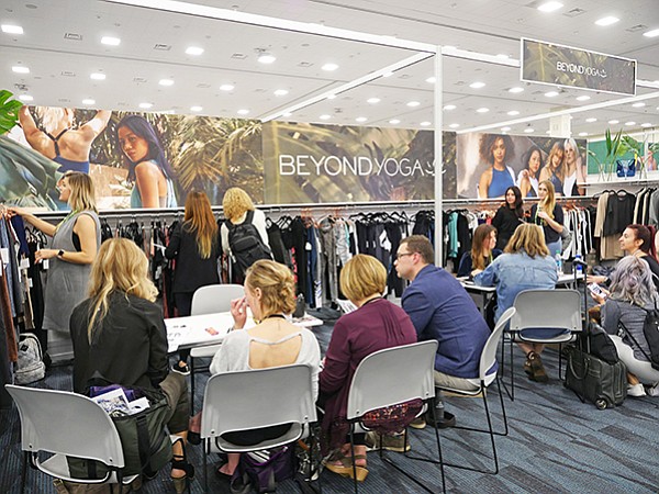 ACTIVE COLLECTIVE: A steady flow of buyers shopped the Active Collective trade show Jan. 11–12 in Anaheim, Calif. Above, meetings at the Beyond Yoga brand’s booth. 