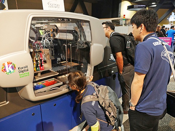 ISS attendees check out a Kornit Avalanche HD6 printer.