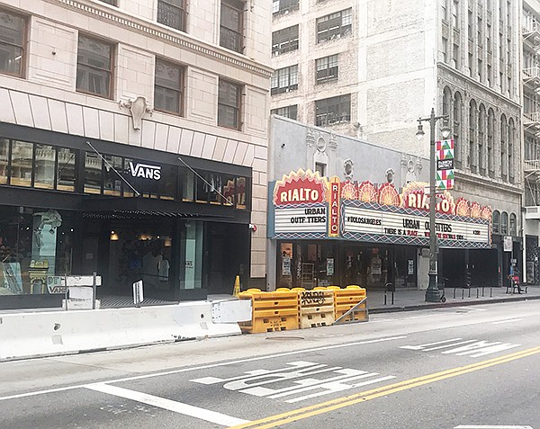Vans and Urban Outfitters stores temporarily closed on Broadway in downtown Los Angeles, which was empty due to coronavirus closures.