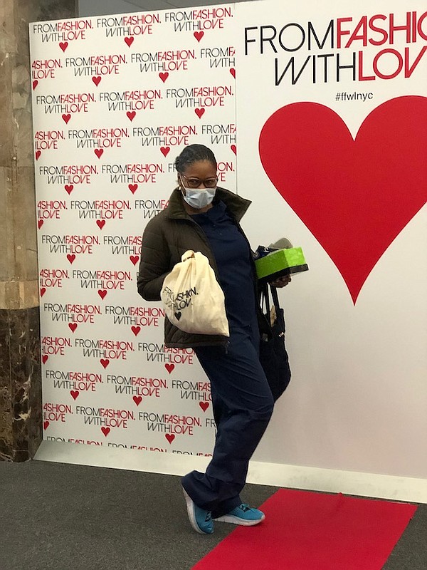 Nurse poses with From Fashion With Love gift bag at a New York City event earlier this year. Image courtesy From Fashion With Love