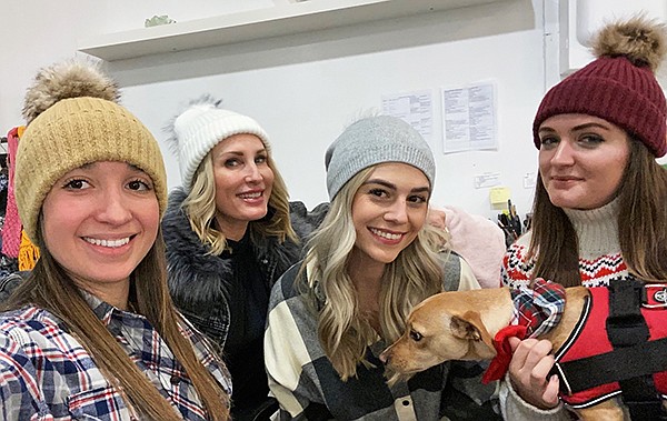 Virginia Wolf beanies at the Cooper’s Agency Showroom (right), modeled—from left—by Alejandra Pimienta, showroom coordinator; Stacy Holmes, owner; Niki Williams, sales manager; Brooke Denune, sales assistant; and Finley Guard Dog, greeter | Photo courtesy of Agency Showroom