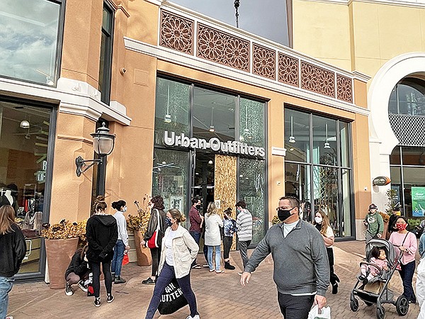 Shoppers at the Irvine Spectrum Center on Dec. 12 and The Grove (below) on Dec. 19 contribute to a successful holiday-sales season as they shop despite economic challenges during 2020.