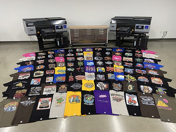 A display features 100 T-shirts made by two F3070 printers in one hour.