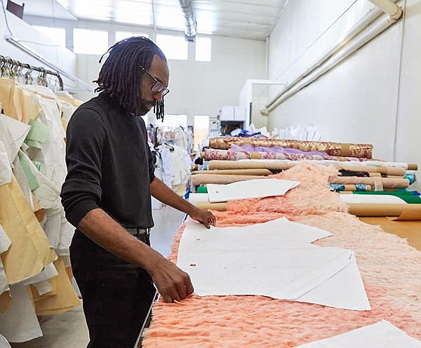 Designer Kevan Hall works on his Kevan Hall Studio collection for Saks OFF 5th, which appeals to women who want style at a lower cost.