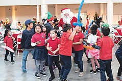 Neighborhood Kids Meet Santa and Receive Gifts at the Annual Holiday Party by CFF and TALA