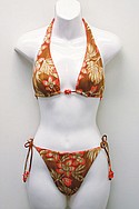 J.LO by JENNIFER LOPEZ SWIMs nylon/spandex Grass Matt Floral reversible orange slider halter ($25) and side-tie hip-hugger ($23).