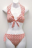 LIQUID BLUEs orange-and-cream Lytex Pascal Dot tie-front ruffle halter and side-tie hipster (call for pricing).