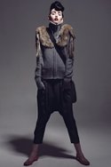 EVER's gray Merino wool "Nawa" knit sweater with rabbit-fur appliqué ($200) and black "Raqqada" drop-crotch slouch trouser ($110). MATT & NAT's "BRMC" recycled-water-bottle felt messenger bag ($90). TARYN ROSE's patent-leather "Boca" flats in candy-apple red ($242).