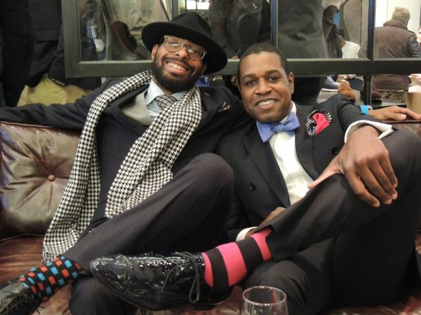 Manny J of Gent's Closet, left, in an Albert Minge suit and a hat by Goorin Bros. At right, Stacy Branden in a custom suit by Stacey Branden. Branden has worked with celebrities such as Justin Timberlake, Timbaland, and Josh Groban. Branden said that he's trying to convince the world's stylish men to try on custom, double breasted suits. It was a look that showed a strong physique and panache, he said.