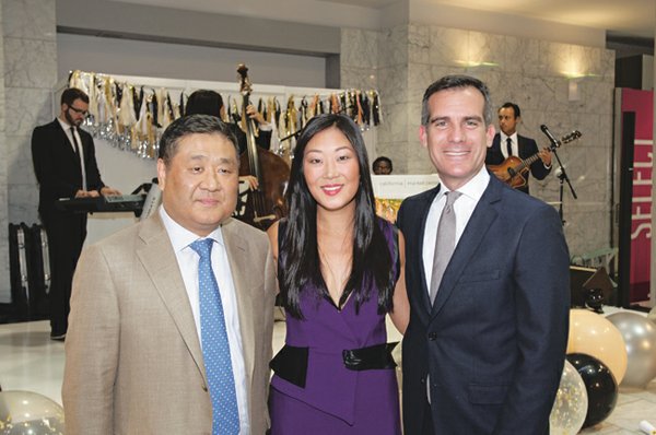 Jamison Services owner David Lee; his daughter and CMC president, Jaime Lee; and Los Angeles Mayor Eric Garcetti. The mayor addressed the apparel community at California Market Center's 50th-anniversary event in October. (Photo by Volker Corell)
