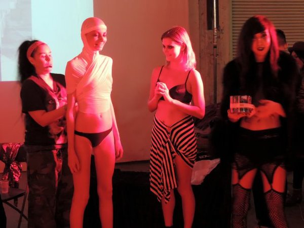 Katarina Lova, pictured center-left, being dressed up by an unidentified audience member in Bohemian Society's performance inspired fashion event. Taylor Dunn, a model, pictured right, and Lucas Logan, pictured far right.