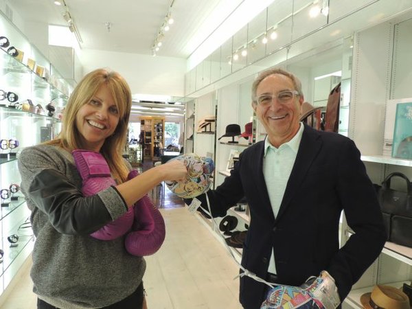 Duking it out, wearing Elizabeth Weinstock boxing gloves, are Karen Meena, vice president of buying and merchandising of Ron Robinson, and Ron Robinson.