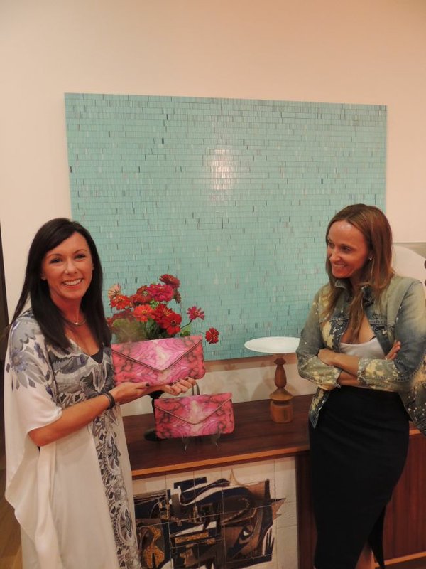 Party at Cheyann Benedict boutique in Los Angeles. On Oct. 18, Christie Casillo, of Coastal Road, held up clutch purse, which is part of the collaboration collection between Coastal Road and Cheyann Benedict. Cheyann Benedict, pictured on right.