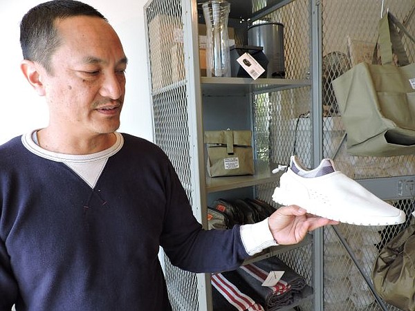 Richard Cofinco holding ASIF footwear.