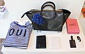 “Oui” striped shirt ($165), black tote ($499), leather passport cases ($115), leather luggage tags ($55), Louis Vuitton LA City Guide book ($37)