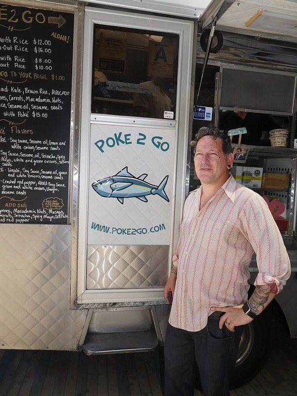 Phillip Dane in front of the Poke 2 Go truck at the CMC.