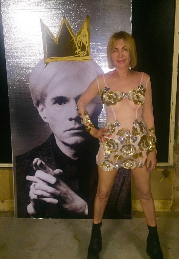 Artist Karen Bystedt, wearing a couture dress by Sonia Ete’, pictured with her large crowed Warhol. 