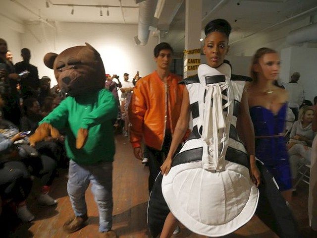 At finale of April 20 runway show, The B. James Experience, a woman dressed in a Shell Toe Adidas sneaker dress, center. Also a man dressed like D Bear, the B. James line's mascot. 