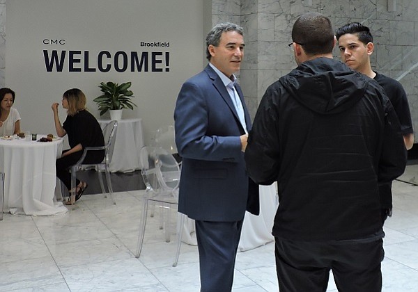 David Foley, the new general manager of the California Market Center (at left), meets with tenants at a meet-and-greet event on June 19. 