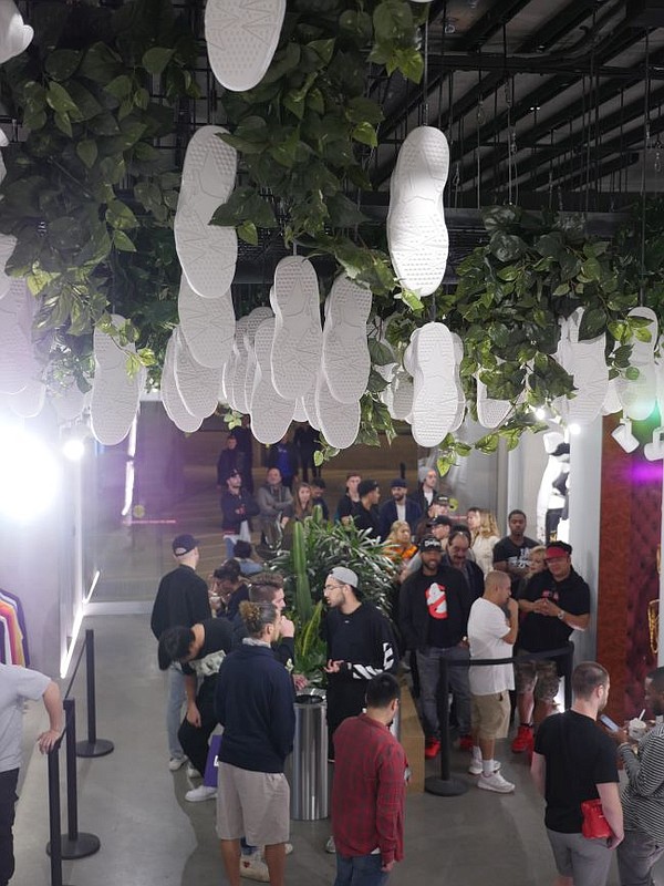 Under a ceiling of hanging sneakers, crowds shop at Kith Feb. 19