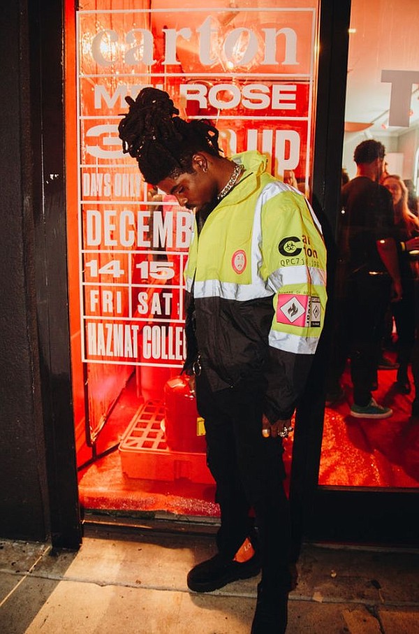 Trying on a Carton Outerwear jacket at the brand's pop-up shop Dec. 14. Photo by Dolly Nguyen