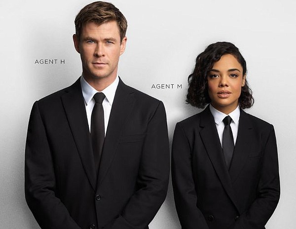 Chris Hemsworth and Tessa Thompson in Paul Smith's black suit. Image via paulsmith.com/us