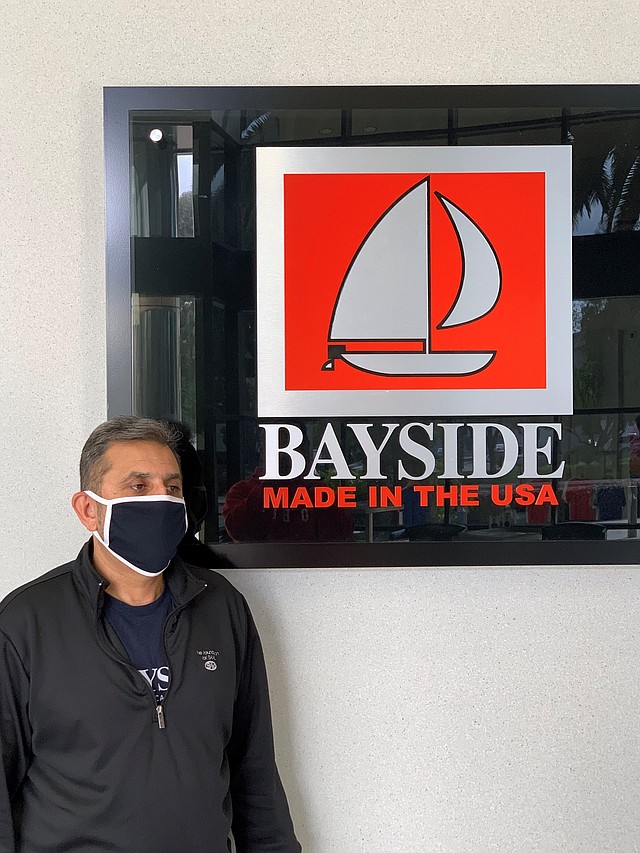 AST Sportswear/Bayside Apparel Chief Operating Officer Abdul Rashid wears a mask manufactured by the company.