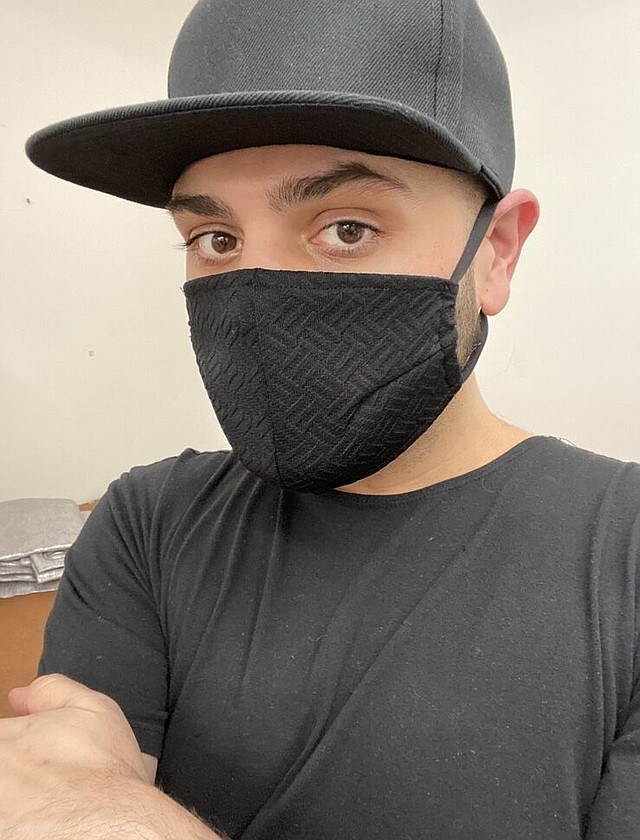 Michael Costello with a face mask that he designed. Image courtesy Michael Costello