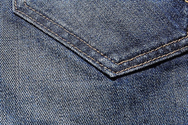 Red denim jeans with a seam texture background